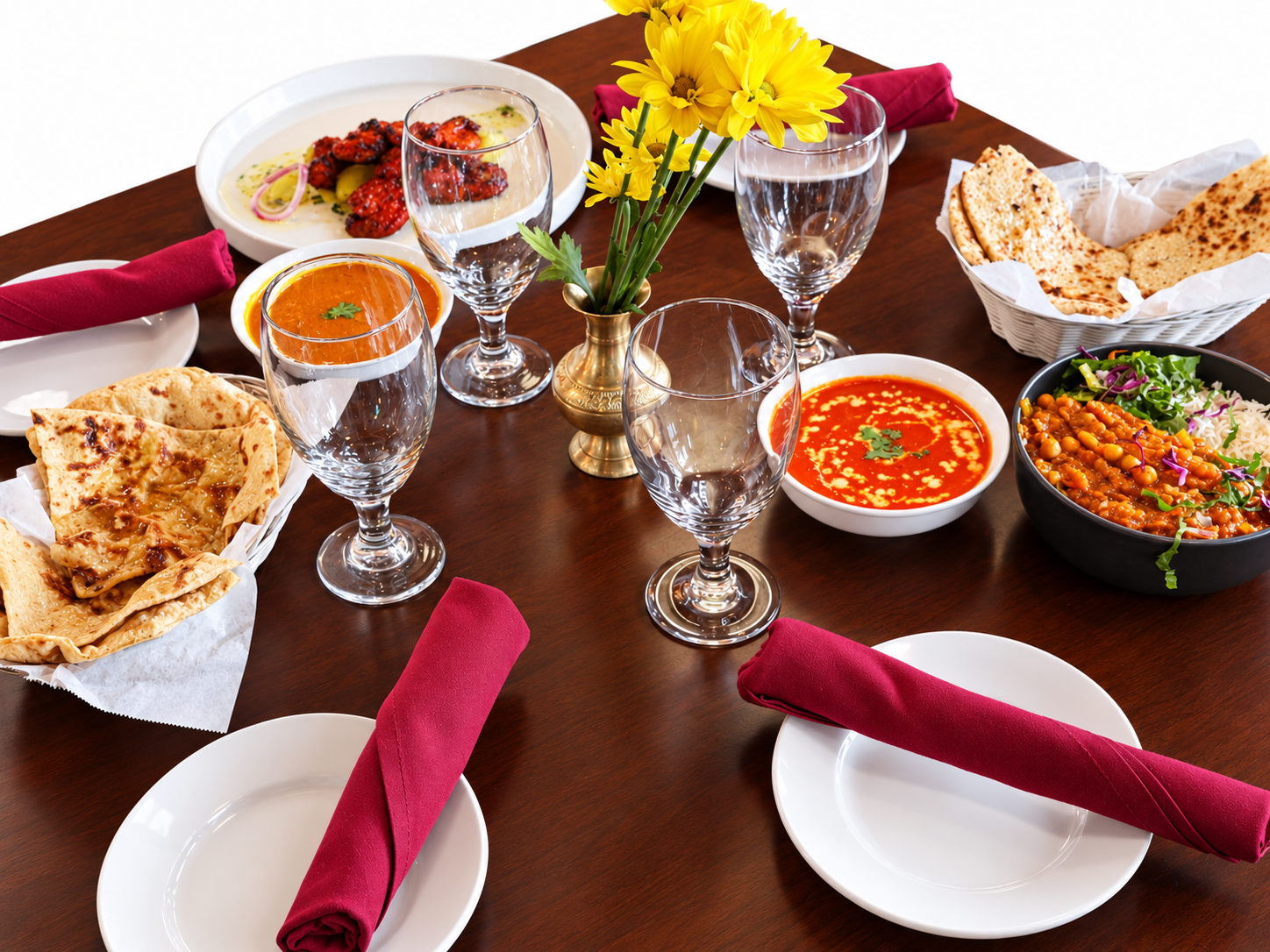 Momos, curry and naan on a table at Himchuli, a Nepali restaurant in Denver