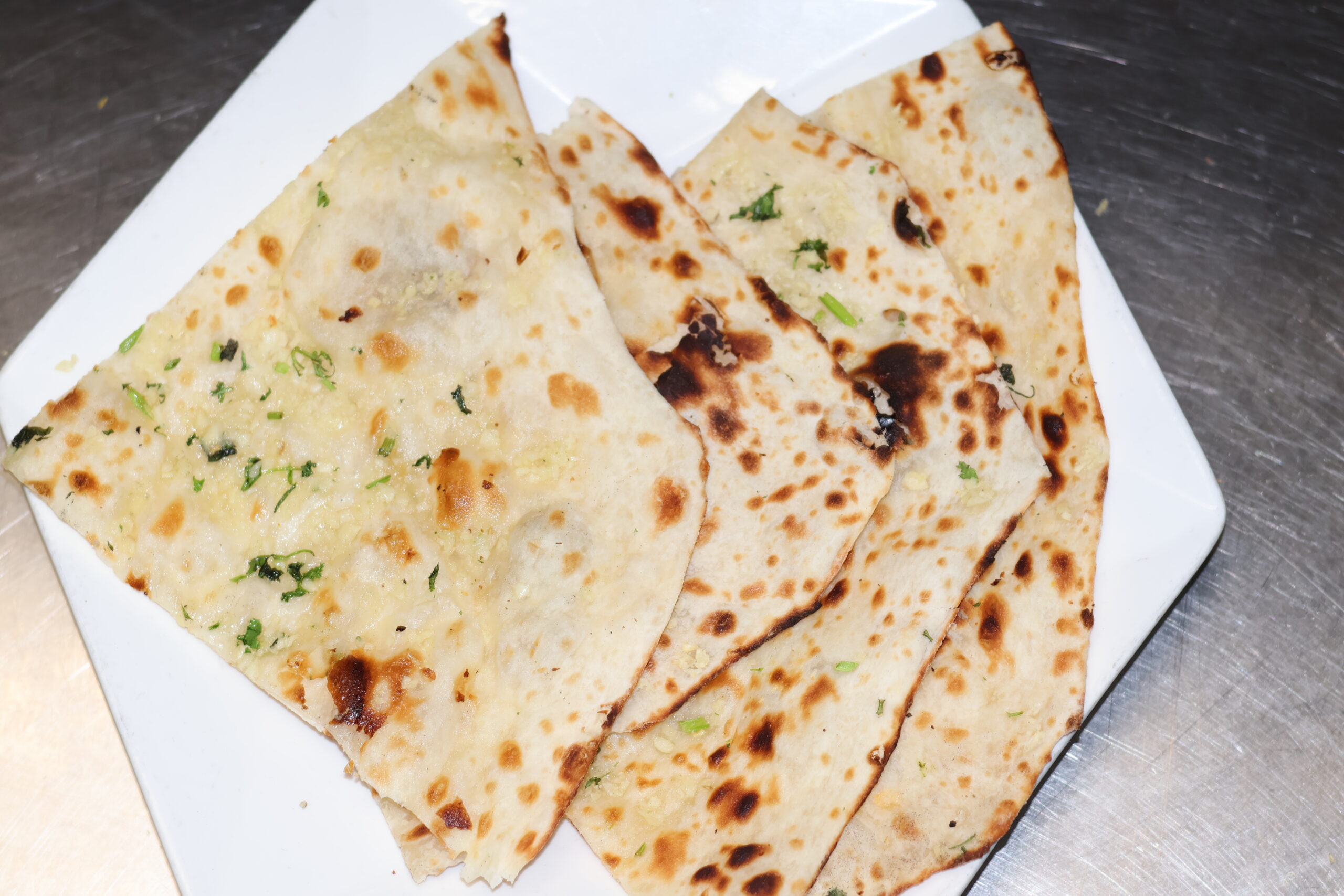 Fresh garlic naan from the tandoor at Himchuli in Denver