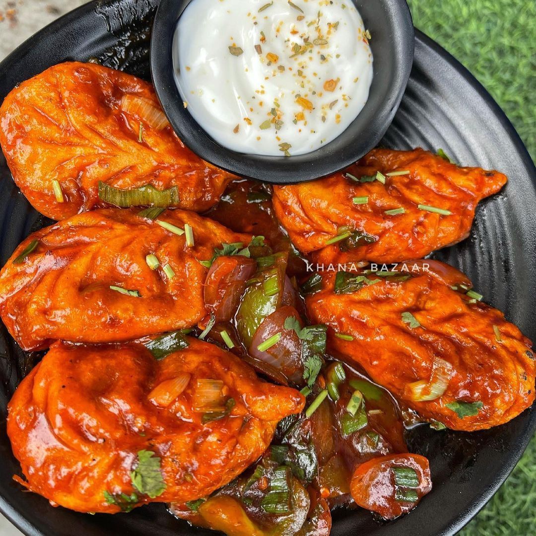 Chilli momos tossed with peppers and onion at Himchuli in Denver
