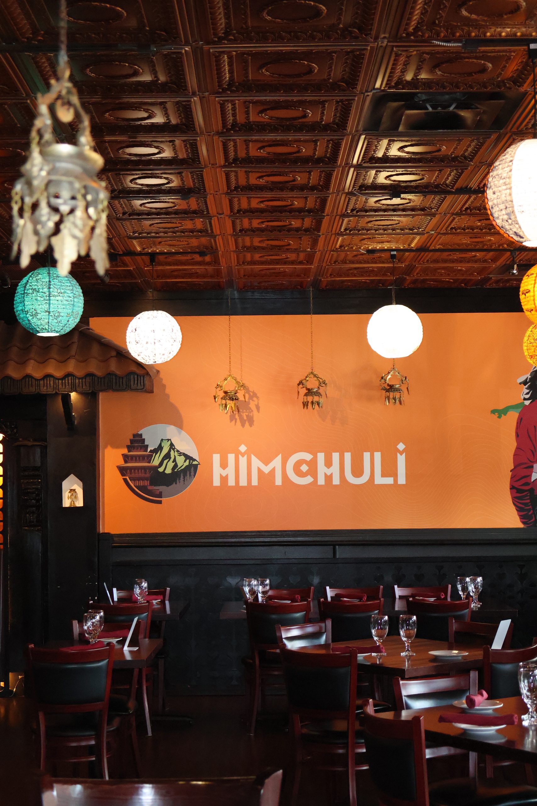Momos, curry, naan and mango lassi on a table at Himchuli Highlands in Denver